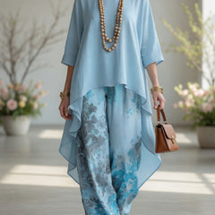 Light blue long tunic top and wide-leg printed pants set with flowy layered hems