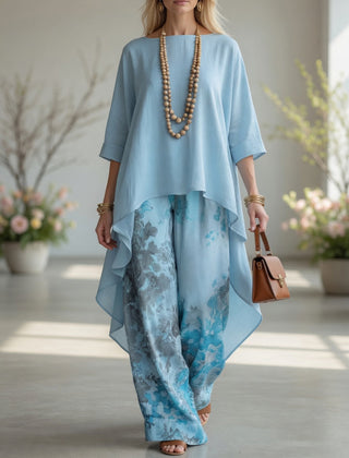 Light blue long tunic top and wide-leg printed pants set with flowy layered hems