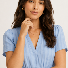 Solene dress in light blue seersucker, V-neck with smocked waist detail.