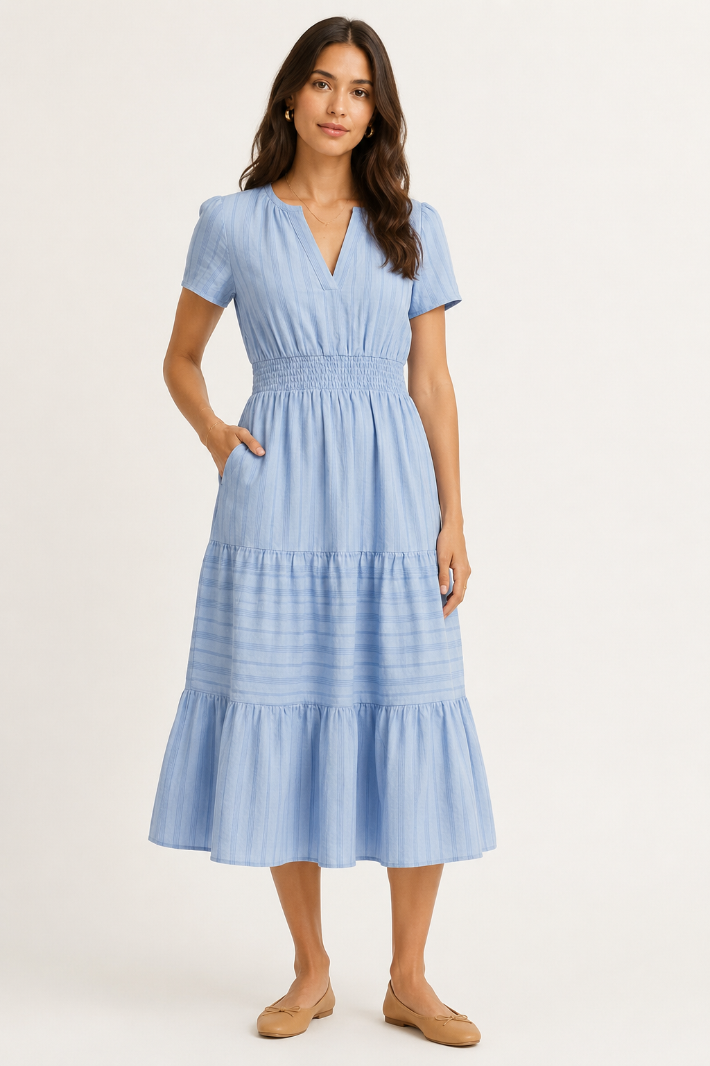Solene dress in light blue seersucker, V-neck short sleeves, tiered midi skirt.