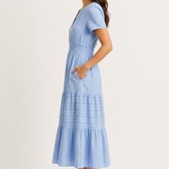 Solene dress in light blue seersucker, V-neck short sleeves, tiered midi skirt.