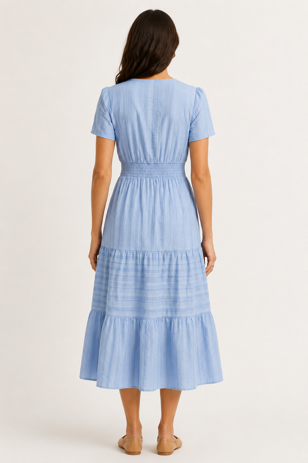 Solene dress in light blue seersucker, back view with smocked waist and tiered skirt.
