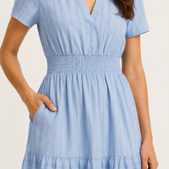 Solene dress in light blue seersucker, V-neck and gathered smocked waist, tiered skirt.