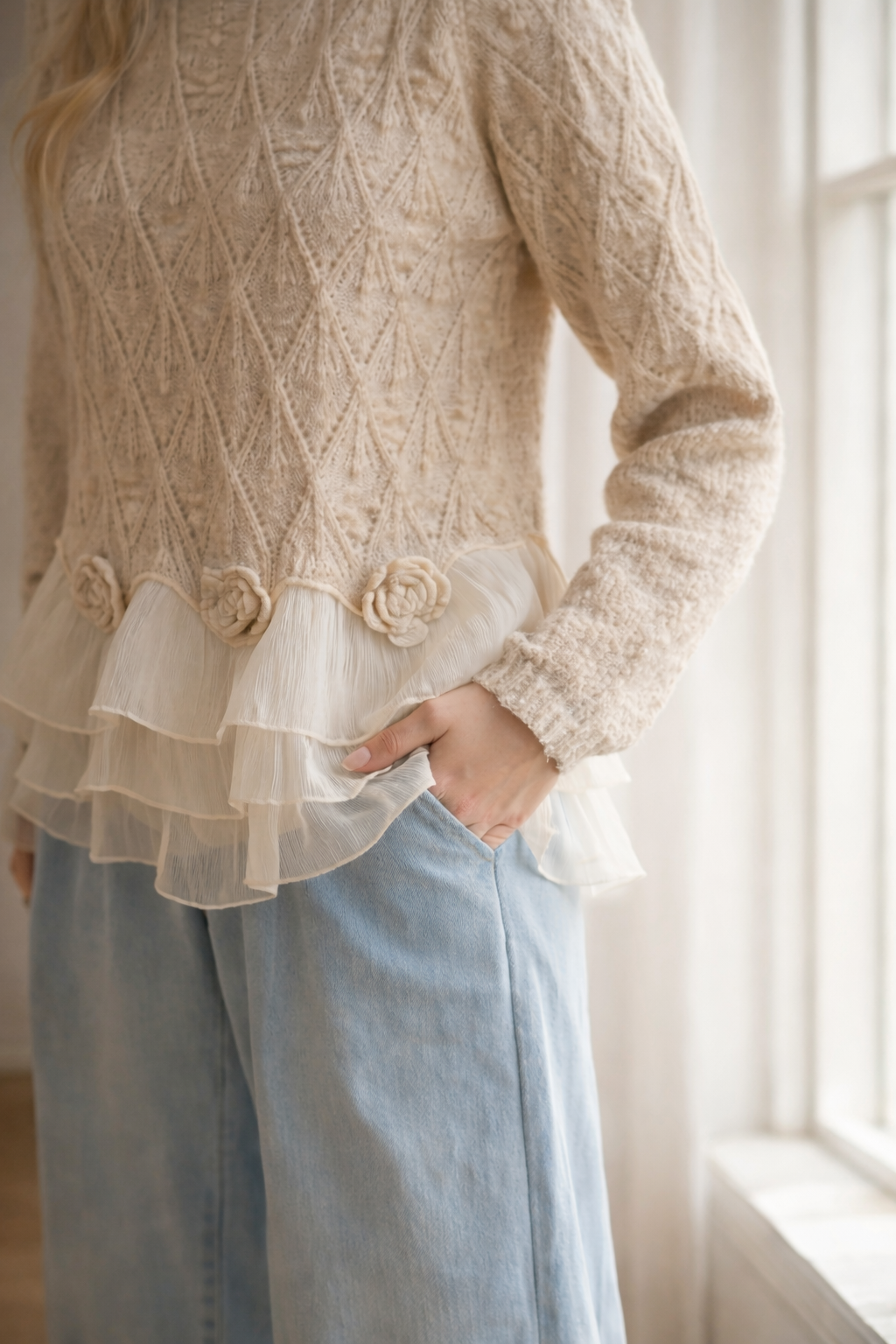 Cream textured cardigan with flower appliques and layered ruffle hem.
