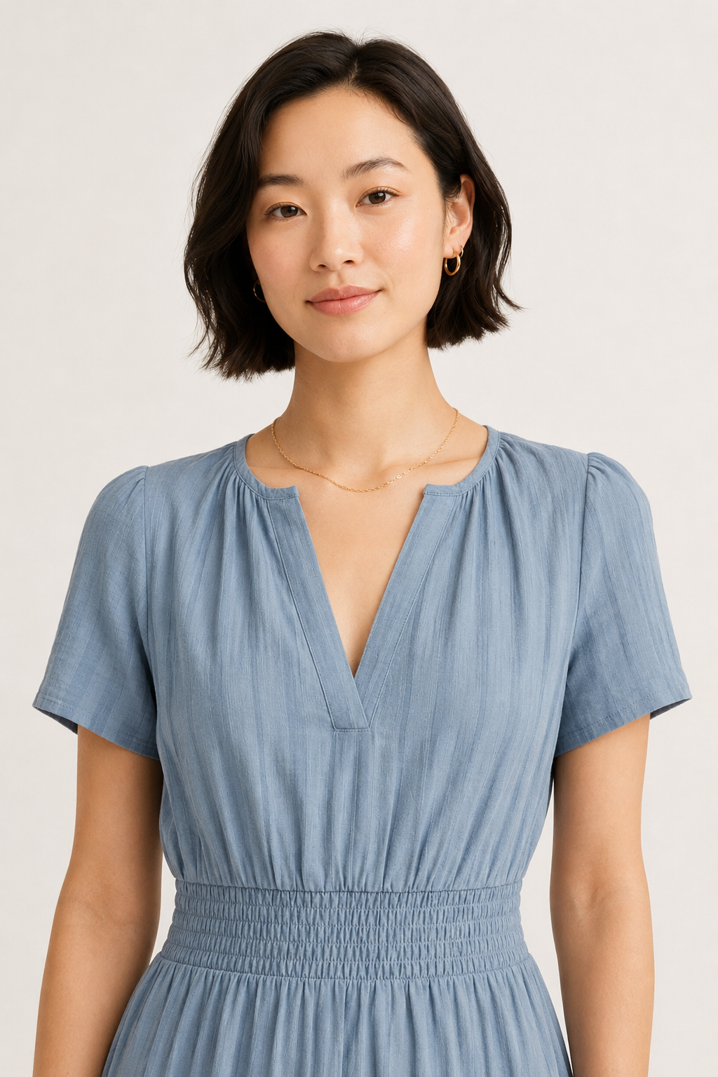 Light blue V-neck short-sleeve dress with elastic waist and textured tiered skirt