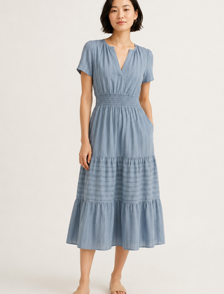 Light blue tiered V-neck midi dress with short sleeves and gathered waist