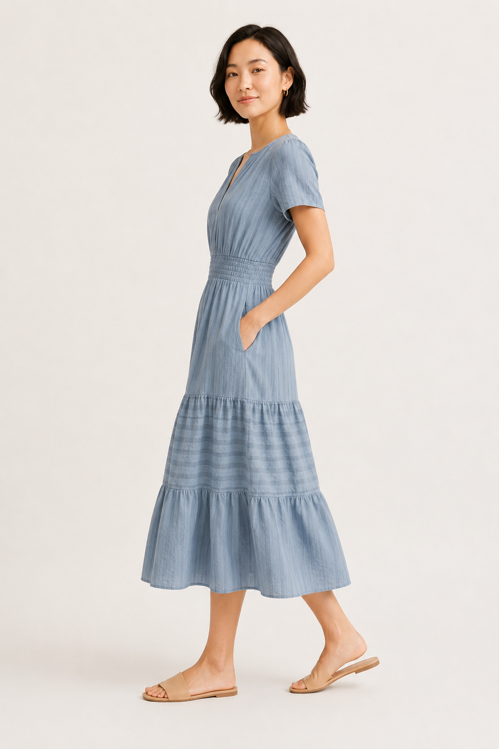 Light blue tiered V-neck midi dress side view with short sleeves and gathered waist
