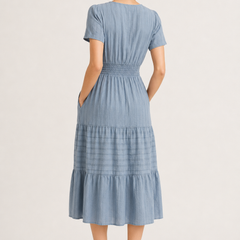 Light blue tiered V-neck midi dress back view with gathered waist and short sleeves