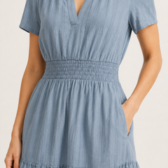 Light blue V-neck midi dress close-up: gathered waist and tiered hem layers