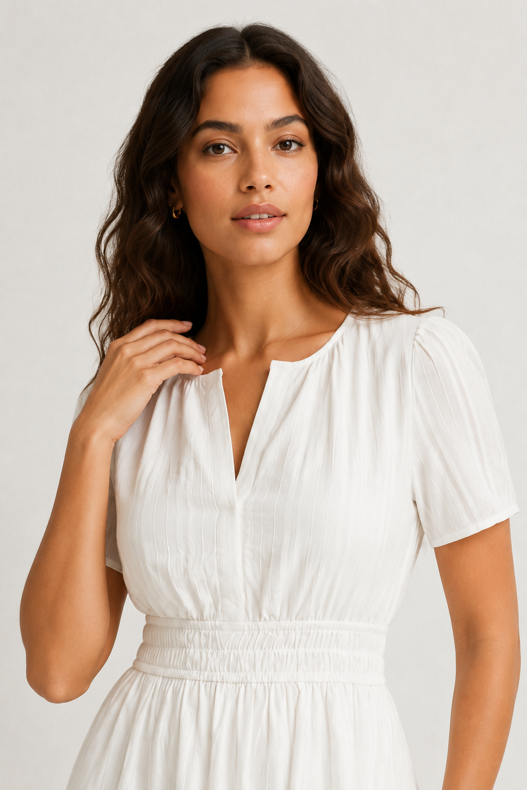 Solene dress close-up: white V-neck with pintuck texture, short puff sleeves, gathered waist