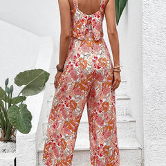 Apricot-orange floral wide-leg jumpsuit, sleeveless with open back, gathered waist