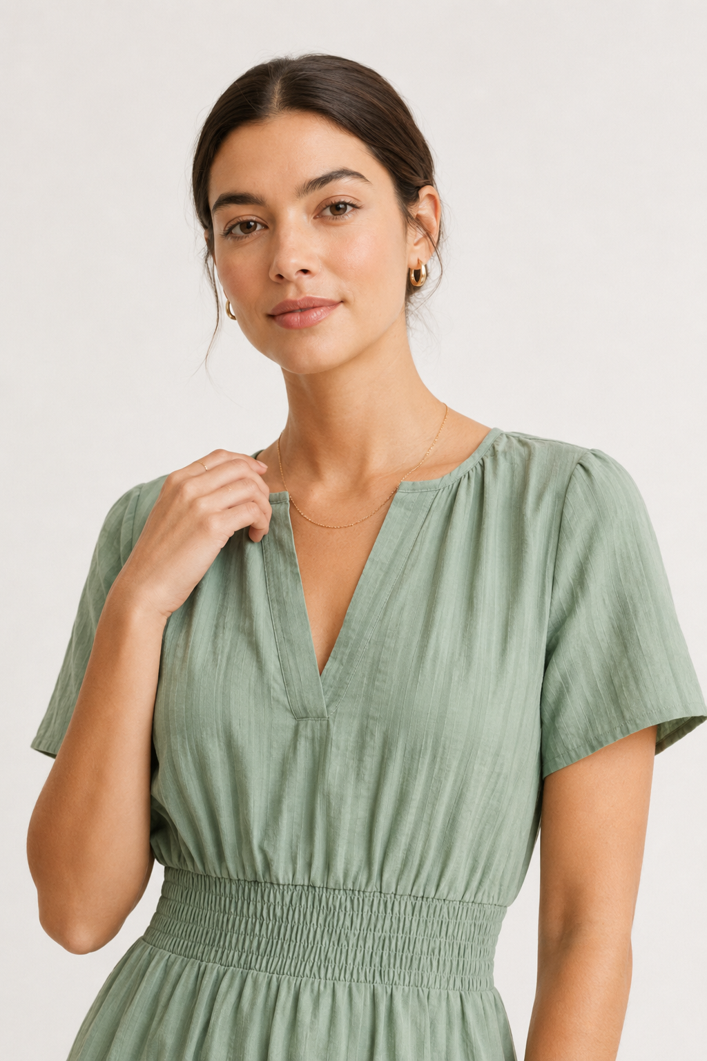 Solene dress close-up, eucalyptus green V-neck with short sleeves and smocked waist