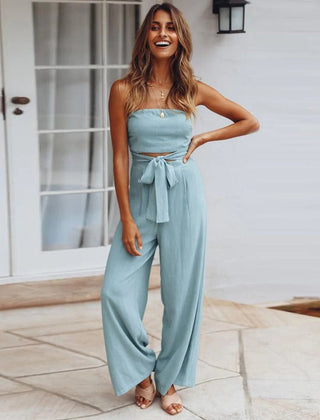 Light blue strapless jumpsuit with tie waist and wide-leg trousers