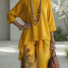 Mustard yellow long tunic top and wide-leg printed pants set with draped hem