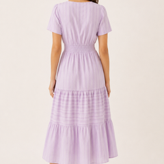 Solene dress in lavender seersucker, back view with smocked waist and tiered skirt.