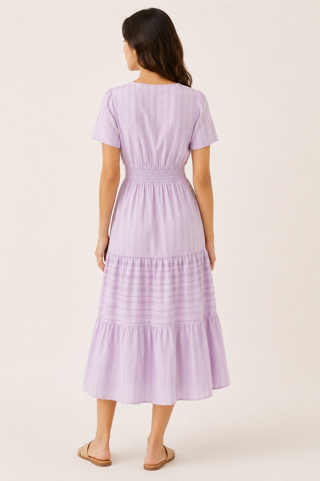 Solene dress in lavender seersucker, back view with smocked waist and tiered skirt.