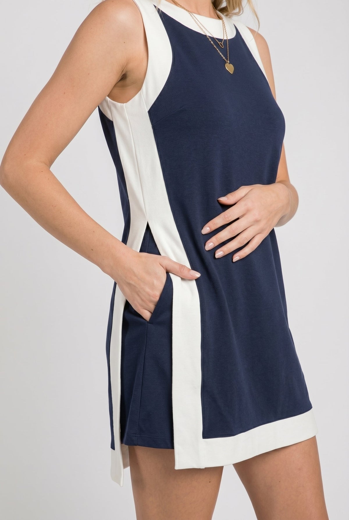 Sleeveless navy game day dress with white trim and side panel cutout