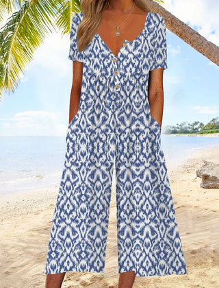 Blue patterned jumpsuit with V-neck button front, short sleeves, and wide legs