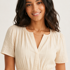 Solene dress portrait close-up, light cream V-neck, short sleeves, gathered waist seam