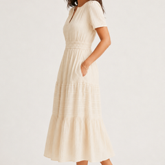 Solene dress side profile in light cream, V-neck, gathered waist, tiered mid-length skirt