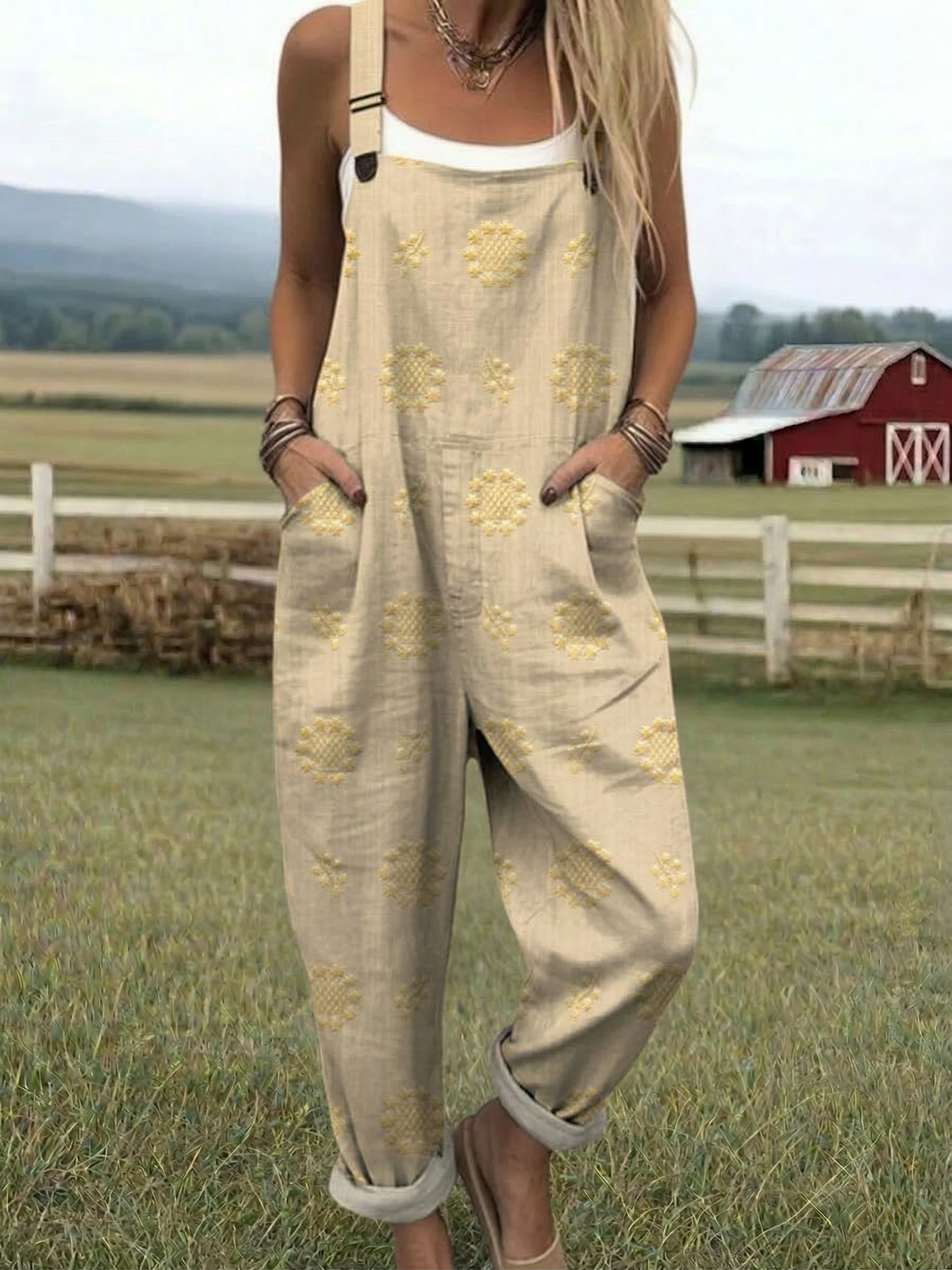 Light yellow relaxed jumpsuit with embroidered floral pattern, wide-leg bib overalls