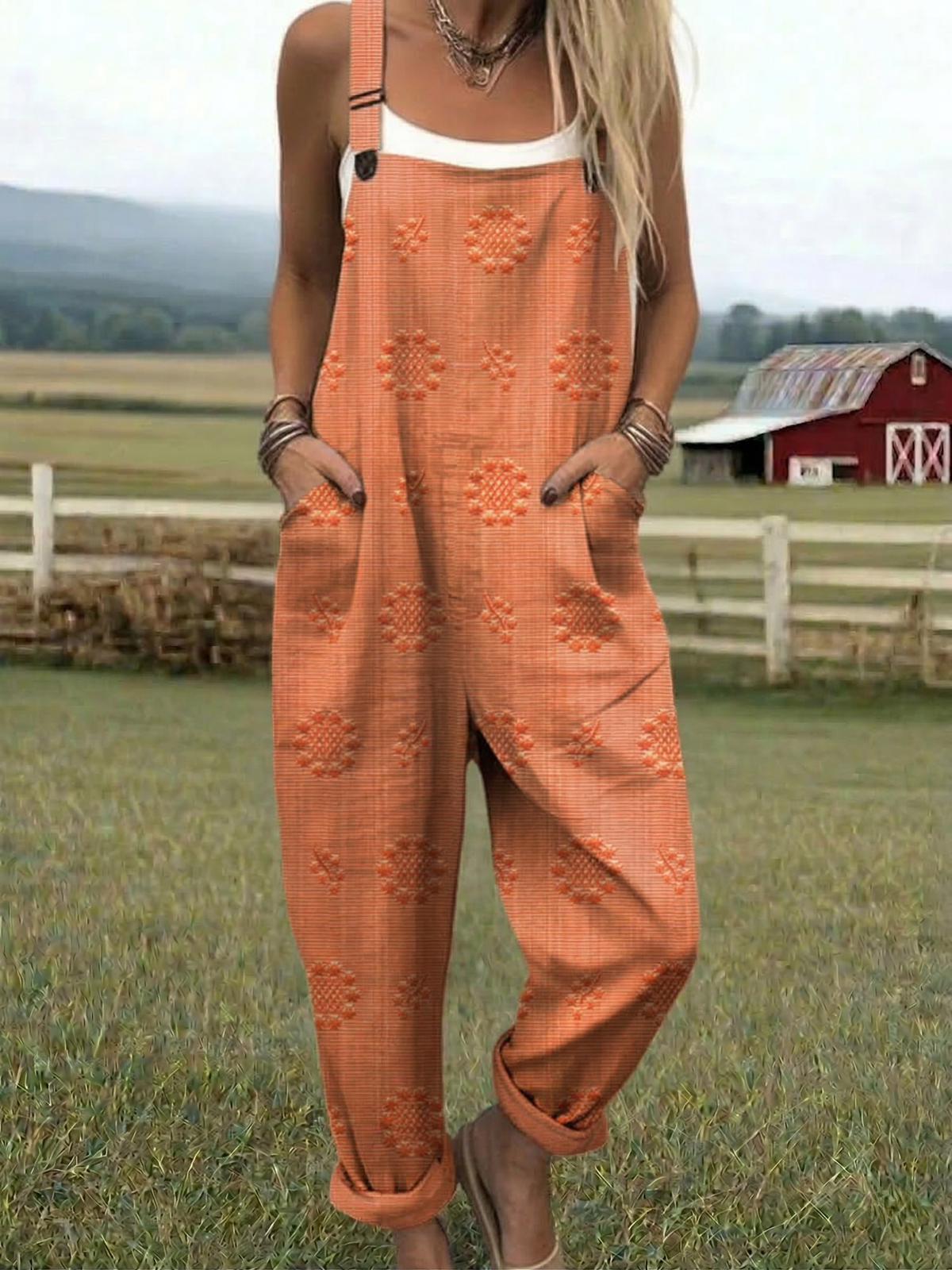 Orange relaxed jumpsuit with embroidered floral pattern, wide-leg bib overalls