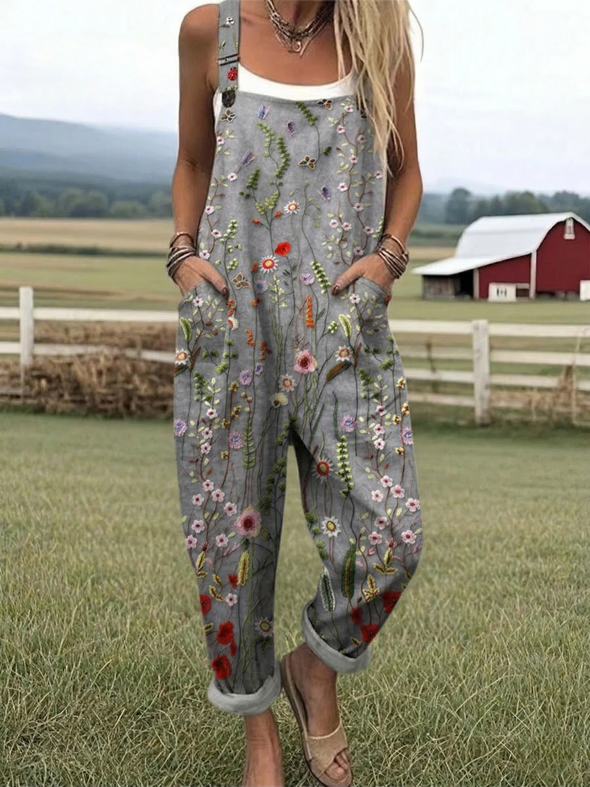 Floral print sleeveless jumpsuit with gray base and wide-leg overalls, front pockets