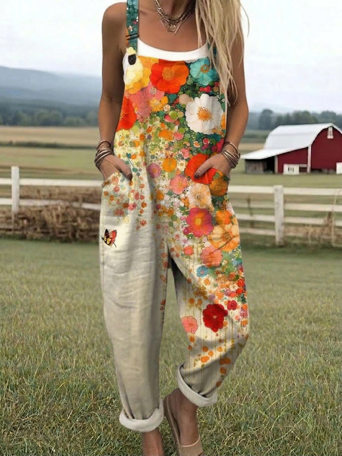 Floral jumpsuit with multicolor print, wide straps, relaxed straight-leg fit.