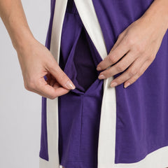 Detail of sleeveless purple game day dress with white panels and side pocket