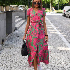 Green and pink floral wrap dress with short sleeves and V-neck, belted waist