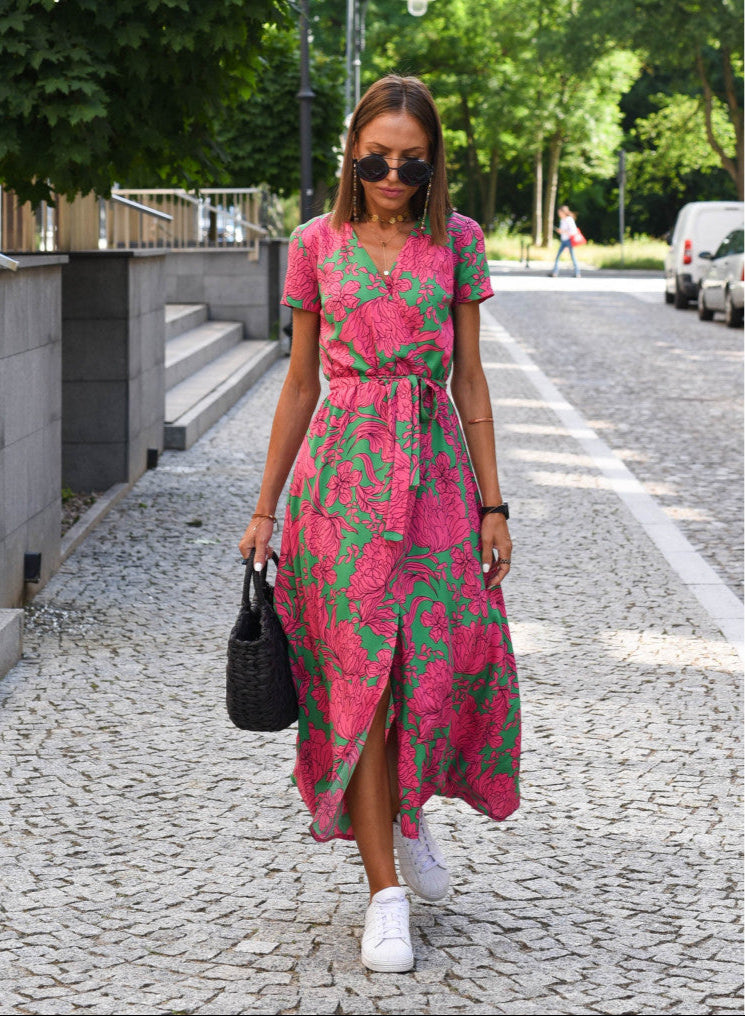 Green and pink floral wrap dress with short sleeves and V-neck, belted waist