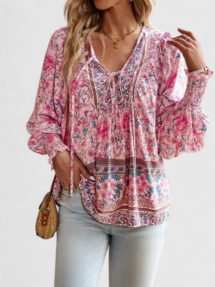 Pink floral peasant blouse with gathered V-neck and ruffled cuffs