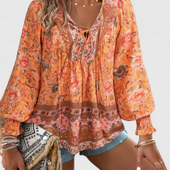 Orange printed peasant blouse with round neckline, elastic cuffs, long balloon sleeves
