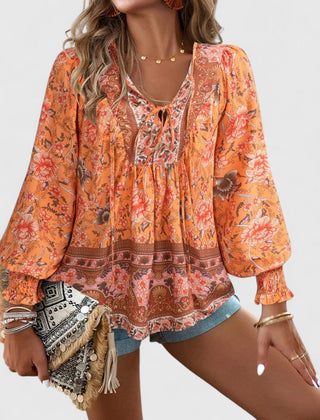 Orange printed peasant blouse with round neckline, elastic cuffs, long balloon sleeves