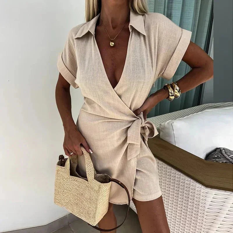 Beige wrap playsuit with tie belt at waist, short sleeves and V-neck