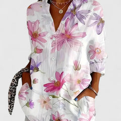 White blouse with pink and purple floral print, button-front, and long sleeves
