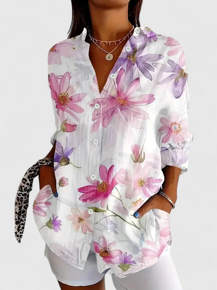 White blouse with pink and purple floral print, button-front, and long sleeves