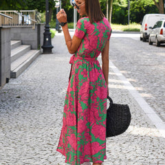 Pink and green floral wrap dress with short sleeves, V-neckline, tied waist