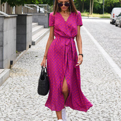 Magenta polka-dot wrap dress with short sleeves, V-neck, and waist tie