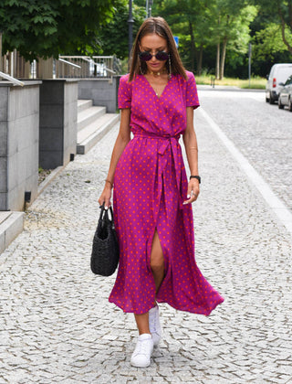 Magenta polka-dot wrap dress with short sleeves, V-neck, and waist tie