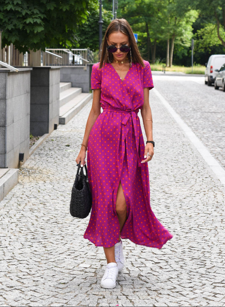 Magenta polka-dot wrap dress with short sleeves, V-neck, and waist tie