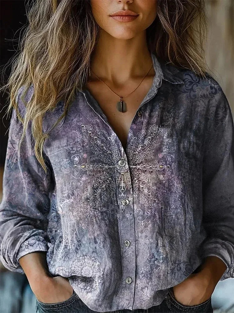 Slate blue patterned button-up blouse with long sleeves and front button placket