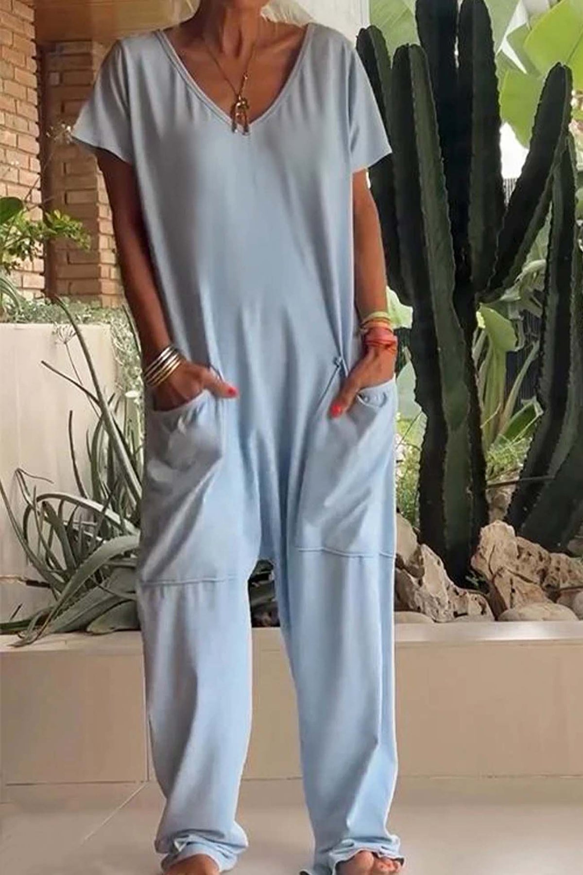 Light blue V-neck short-sleeve jumpsuit with patch pockets and loose tapered legs