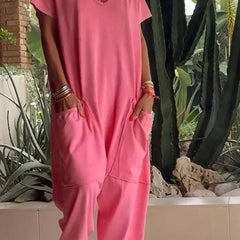 Coral pink V-neck short-sleeve jumpsuit with patch pockets and relaxed jogger legs