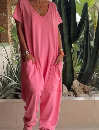 Coral pink V-neck short-sleeve jumpsuit with patch pockets and relaxed jogger legs