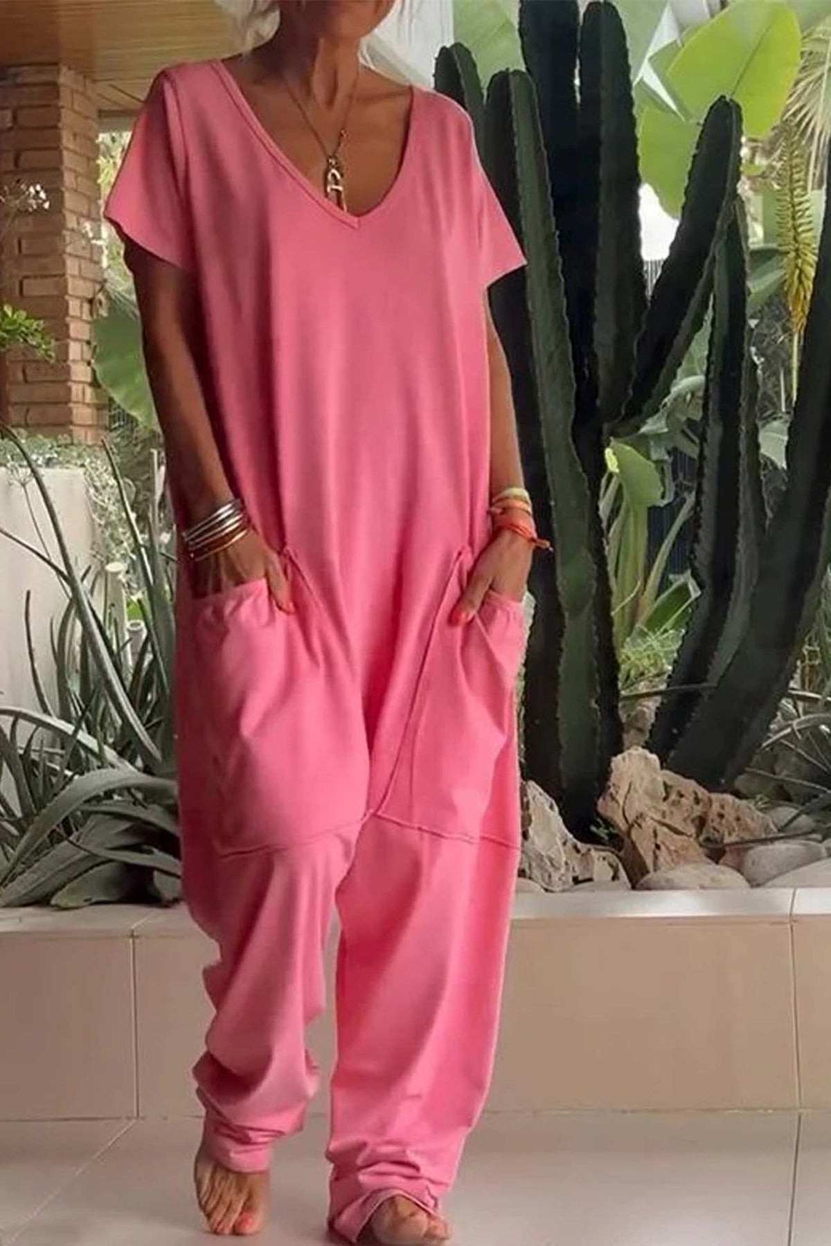 Coral pink V-neck short-sleeve jumpsuit with patch pockets and relaxed jogger legs