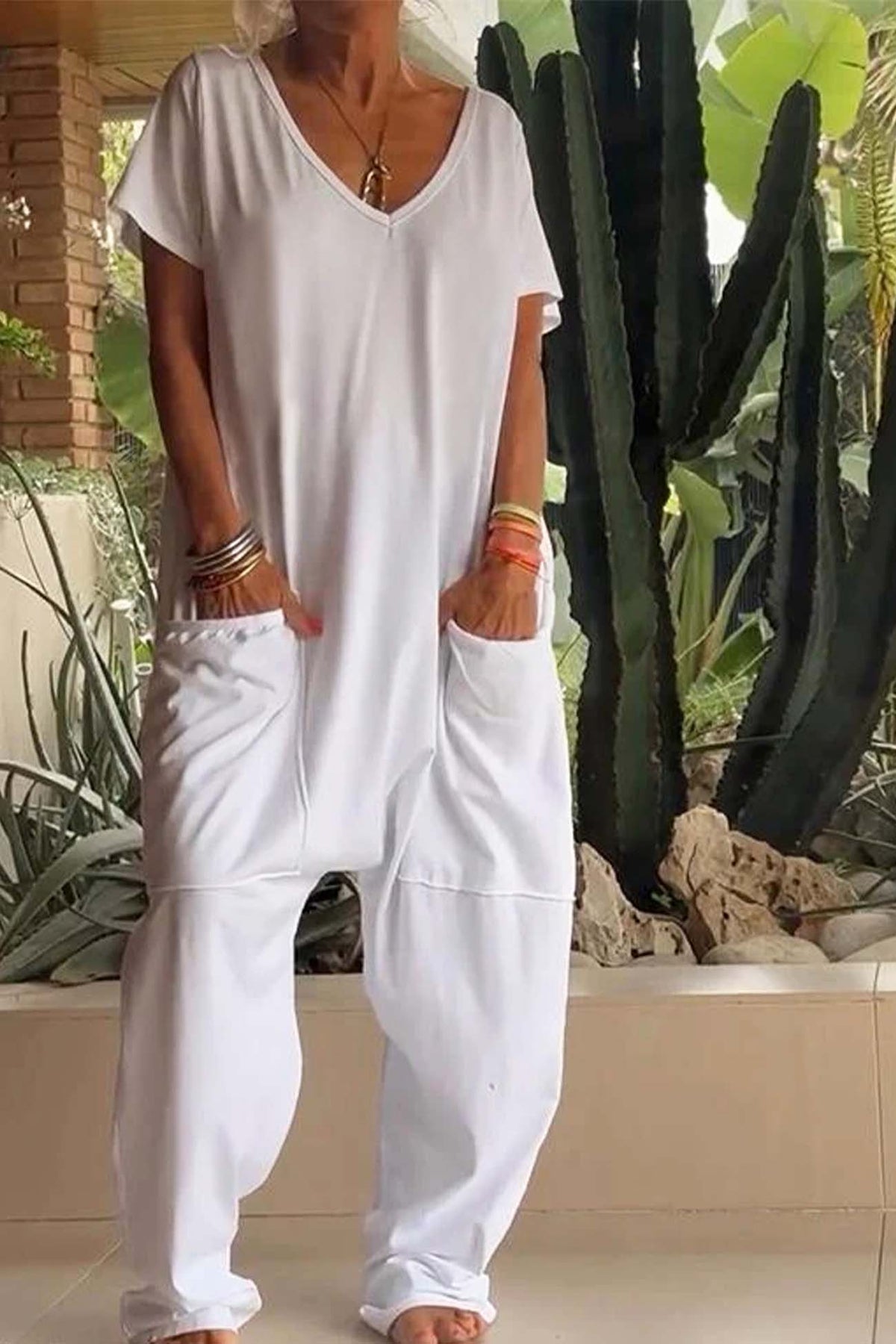 White V-neck short-sleeve jumpsuit with patch pockets and relaxed tapered legs