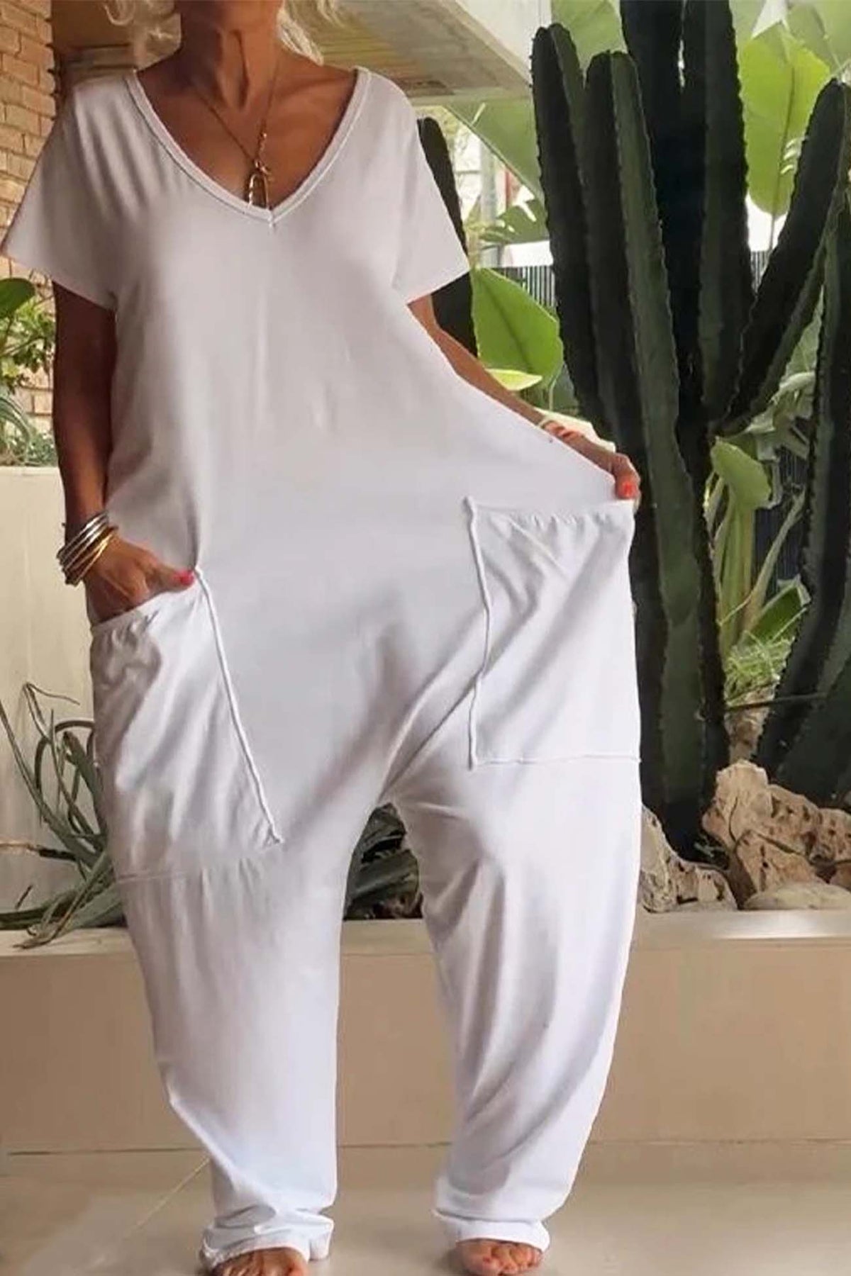 White V-neck short-sleeve jumpsuit with large front patch pocket and relaxed fit