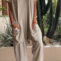Stone beige V-neck short-sleeve jumpsuit with patch pockets and relaxed fit