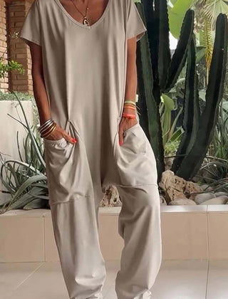 Stone beige V-neck short-sleeve jumpsuit with patch pockets and relaxed fit